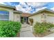 Inviting home exterior with manicured landscaping, a screened front door, and a beige color scheme at 4811 14Th E Ave, Bradenton, FL 34208