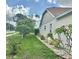 Well-maintained side yard showcasing lush landscaping with flowering bushes at 4811 14Th E Ave, Bradenton, FL 34208