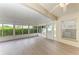 Enclosed Florida room with glass windows, sliding doors, a ceiling fan and durable flooring at 4811 14Th E Ave, Bradenton, FL 34208