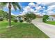 Charming single-story home featuring a lush lawn, mature landscaping, and a two-car garage at 4811 14Th E Ave, Bradenton, FL 34208
