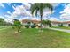 Beautifully landscaped front yard with mature trees, green grass, and a well-maintained lawn at 4811 14Th E Ave, Bradenton, FL 34208