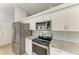 Modern kitchen featuring stainless steel appliances, stone countertops, and ample storage space at 4811 14Th E Ave, Bradenton, FL 34208