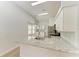 Bright kitchen featuring granite countertops, stainless steel appliances, and modern white cabinetry at 4811 14Th E Ave, Bradenton, FL 34208