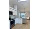 Modern kitchen with white cabinets, granite countertops, and stainless steel appliances at 4811 14Th E Ave, Bradenton, FL 34208