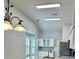 Kitchen featuring modern light fixtures, white cabinets, and stainless steel appliances at 4811 14Th E Ave, Bradenton, FL 34208