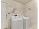 Bright laundry area featuring a washer and dryer with wire shelving above at 4811 14Th E Ave, Bradenton, FL 34208