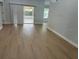 Bright living room featuring modern flooring and an open layout with access to the screened in lanai at 4811 14Th E Ave, Bradenton, FL 34208