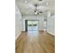 Spacious living room with hardwood floors, ceiling fan and sliding glass doors leading to the lanai at 4811 14Th E Ave, Bradenton, FL 34208