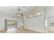 Spacious living room featuring neutral paint, ceiling fan, recessed lights, and sliding glass door to lanai at 4811 14Th E Ave, Bradenton, FL 34208