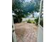 Brick-paved patio surrounded by manicured landscaping and privacy fence at 4811 14Th E Ave, Bradenton, FL 34208