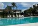 Community pool with lounge chairs under a shaded area, perfect for relaxing and enjoying the sunny weather at 4811 14Th E Ave, Bradenton, FL 34208