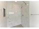 Bright, updated shower with white marble tiling and a sleek, modern design at 4811 14Th E Ave, Bradenton, FL 34208