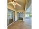 Enclosed sunroom with ceiling fan and multiple sliding doors offering views at 4811 14Th E Ave, Bradenton, FL 34208