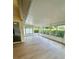 Spacious sunroom featuring white frame windows and wood-look flooring at 4811 14Th E Ave, Bradenton, FL 34208