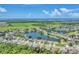 Expansive aerial view of homes surrounding a scenic lake in a vibrant community with lush green spaces and waterfront properties at 5142 51St W Ln, Bradenton, FL 34210