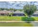 Aerial view of the screened-in pool, backyard, and serene lake of this beautiful property at 5142 51St W Ln, Bradenton, FL 34210