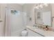 Bright bathroom features a shower-tub combo with white subway tile and a vanity with granite countertop at 5142 51St W Ln, Bradenton, FL 34210