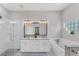 Bright bathroom features a double vanity with granite counters, a walk-in shower, and a separate tub at 5142 51St W Ln, Bradenton, FL 34210