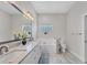 Bathroom features a double vanity with granite counters, a jacuzzi tub, and a glass block window at 5142 51St W Ln, Bradenton, FL 34210