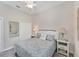 Bedroom featuring a queen sized bed, neutral decor, and ceiling fan at 5142 51St W Ln, Bradenton, FL 34210