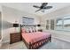 Comfortable bedroom with views of the lake, a ceiling fan, and comfortable queen sized bed at 5142 51St W Ln, Bradenton, FL 34210