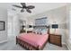 Bedroom features a comfortable queen bed, stylish decor, and a view into the en suite bathroom at 5142 51St W Ln, Bradenton, FL 34210
