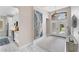 Bright entryway featuring neutral walls, a large abstract painting, tile floors, and a double-door entry with transom window at 5142 51St W Ln, Bradenton, FL 34210