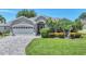 Charming single-story home with well-maintained landscaping and a brick-paved driveway leading to a two-car garage at 5142 51St W Ln, Bradenton, FL 34210