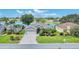 Inviting home featuring a well-maintained lawn and mature landscaping with a tranquil lake backdrop, perfect for relaxation at 5142 51St W Ln, Bradenton, FL 34210