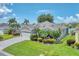 Attractive home boasting lush landscaping, a paved driveway, and a well-manicured lawn with serene lake views in the background at 5142 51St W Ln, Bradenton, FL 34210