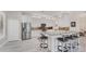 Modern kitchen with white cabinets, stainless steel appliances, granite countertops, and a breakfast bar with seating at 5142 51St W Ln, Bradenton, FL 34210