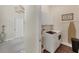 Well-lit laundry room features white cabinets, a washer and dryer, and decorative laundry sign at 5142 51St W Ln, Bradenton, FL 34210