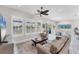 Cozy living room with neutral walls, plantation shutters, a ceiling fan, and comfortable seating for a relaxing atmosphere at 5142 51St W Ln, Bradenton, FL 34210