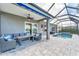 Covered patio with comfortable seating area leading to a screened-in pool and spa at 5142 51St W Ln, Bradenton, FL 34210
