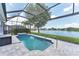 The crystal-clear pool has a spillover spa and calming lake views beyond at 5142 51St W Ln, Bradenton, FL 34210