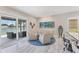 Bright sitting area with chairs, a view of the lake, and sliding glass doors leading to the patio at 5142 51St W Ln, Bradenton, FL 34210