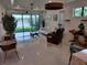 Bright living room with tile floors, large glass doors to backyard, modern furniture and stylish decor at 5219 Barnett Cir, Bradenton, FL 34211