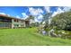Beautiful building overlooking a backyard and a large pond and well-manicured lawn at 5255 Lake Village Dr # 40, Sarasota, FL 34235