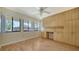 Bright room with light wood floors, ceiling fan, built-in cabinets, and three large windows at 5255 Lake Village Dr # 40, Sarasota, FL 34235