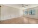 Spacious bedroom with two bright windows and ceiling fan at 5255 Lake Village Dr # 40, Sarasota, FL 34235