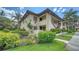 Inviting two-story condo with lush landscaping, a terracotta roof and vibrant tropical surroundings at 5255 Lake Village Dr # 40, Sarasota, FL 34235