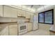 Functional kitchen with granite countertops, tile flooring, and white appliances at 5255 Lake Village Dr # 40, Sarasota, FL 34235