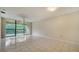 Bright and airy living room featuring tiled floors and a sliding glass door to a private balcony at 5255 Lake Village Dr # 40, Sarasota, FL 34235