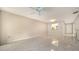 Sun-filled living room area with tile floor and view to kitchen at 5255 Lake Village Dr # 40, Sarasota, FL 34235