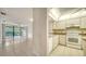 Open living space flows to the kitchen with tile floors and a balcony overlooking the tropical community at 5255 Lake Village Dr # 40, Sarasota, FL 34235