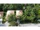 Aerial view showcases the home's roof, screened-in pool, and surrounding greenery at 6744 Hickory Hammock Cir, Bradenton, FL 34202