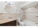 Bathroom with tiled walls, updated vanity with granite counters, and shower/tub combination at 6744 Hickory Hammock Cir, Bradenton, FL 34202
