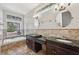 Luxurious bathroom with dual sinks, granite countertops, and a jacuzzi tub overlooking the backyard at 6744 Hickory Hammock Cir, Bradenton, FL 34202
