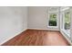 Bright room showcasing wood floors, arched window, and a view of trees from the second window at 6744 Hickory Hammock Cir, Bradenton, FL 34202