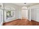 Inviting room with wood floors, arched windows, and a closet door opening to another room at 6744 Hickory Hammock Cir, Bradenton, FL 34202